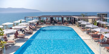 a swimming pool with umbrellas and chairs