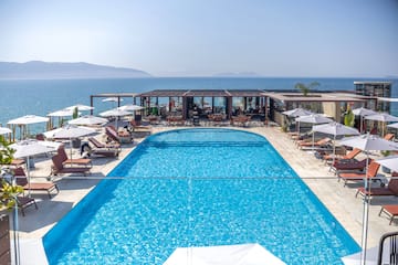 a swimming pool with umbrellas and chairs