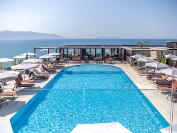 a swimming pool with umbrellas and chairs