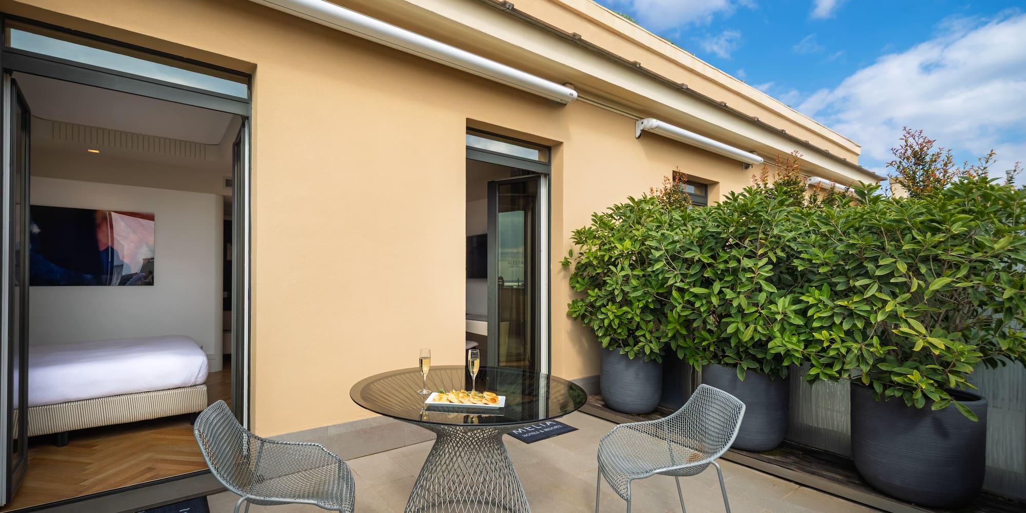 a patio with a table and chairs