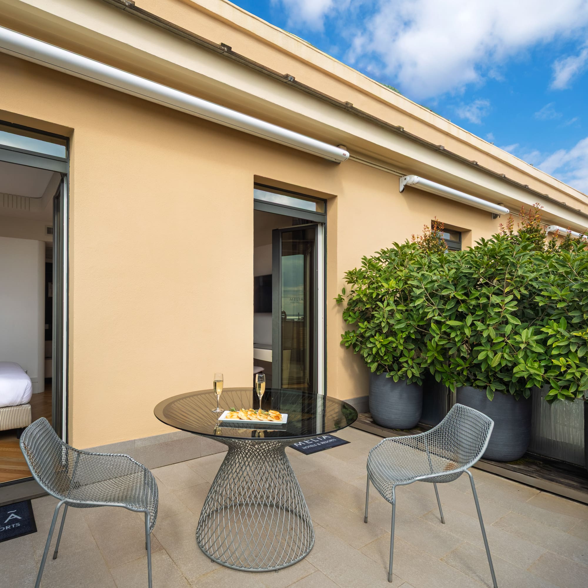 a patio with a table and chairs