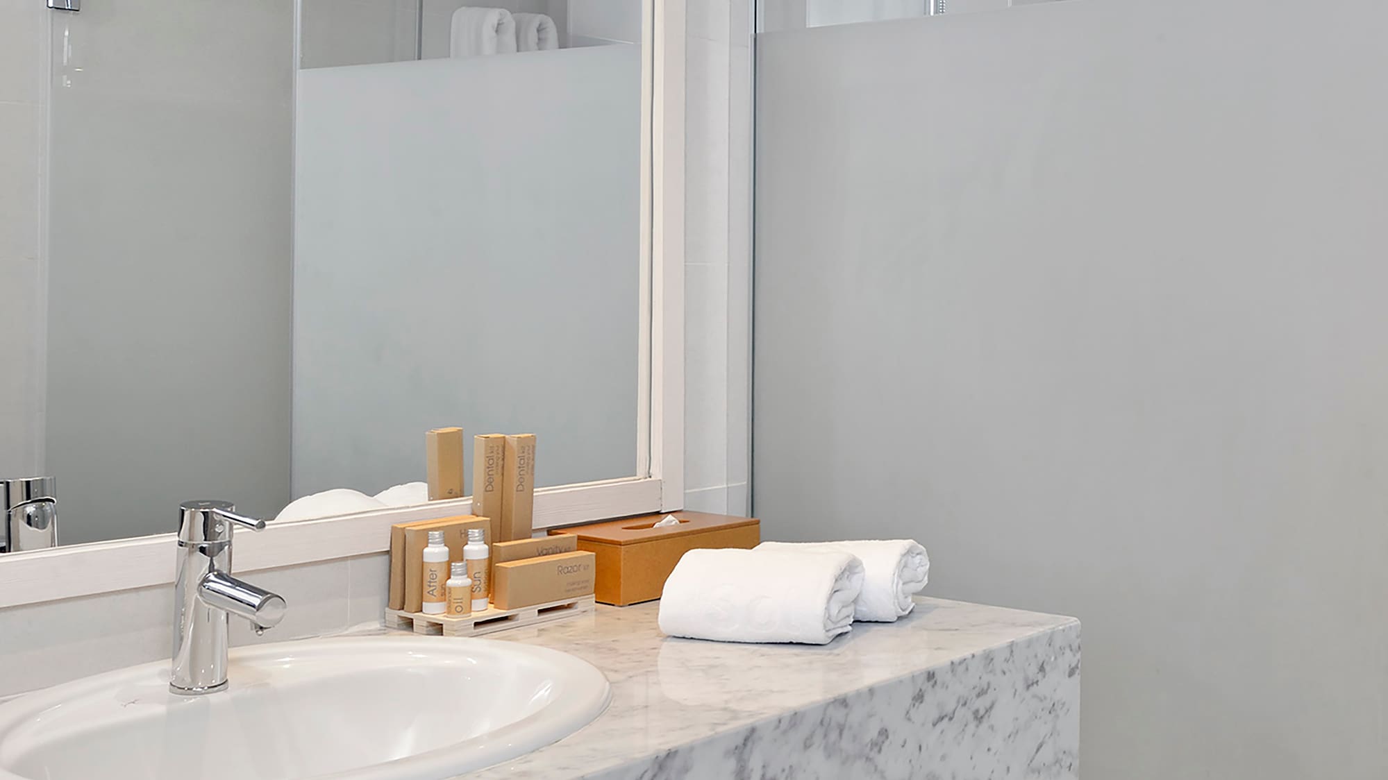 a bathroom with a marble countertop and a shower
