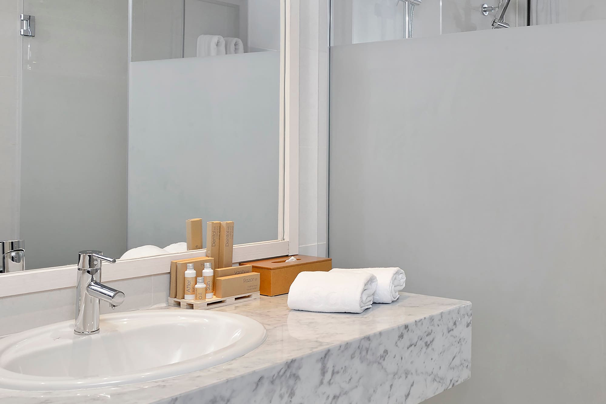 a bathroom with a marble countertop and a shower