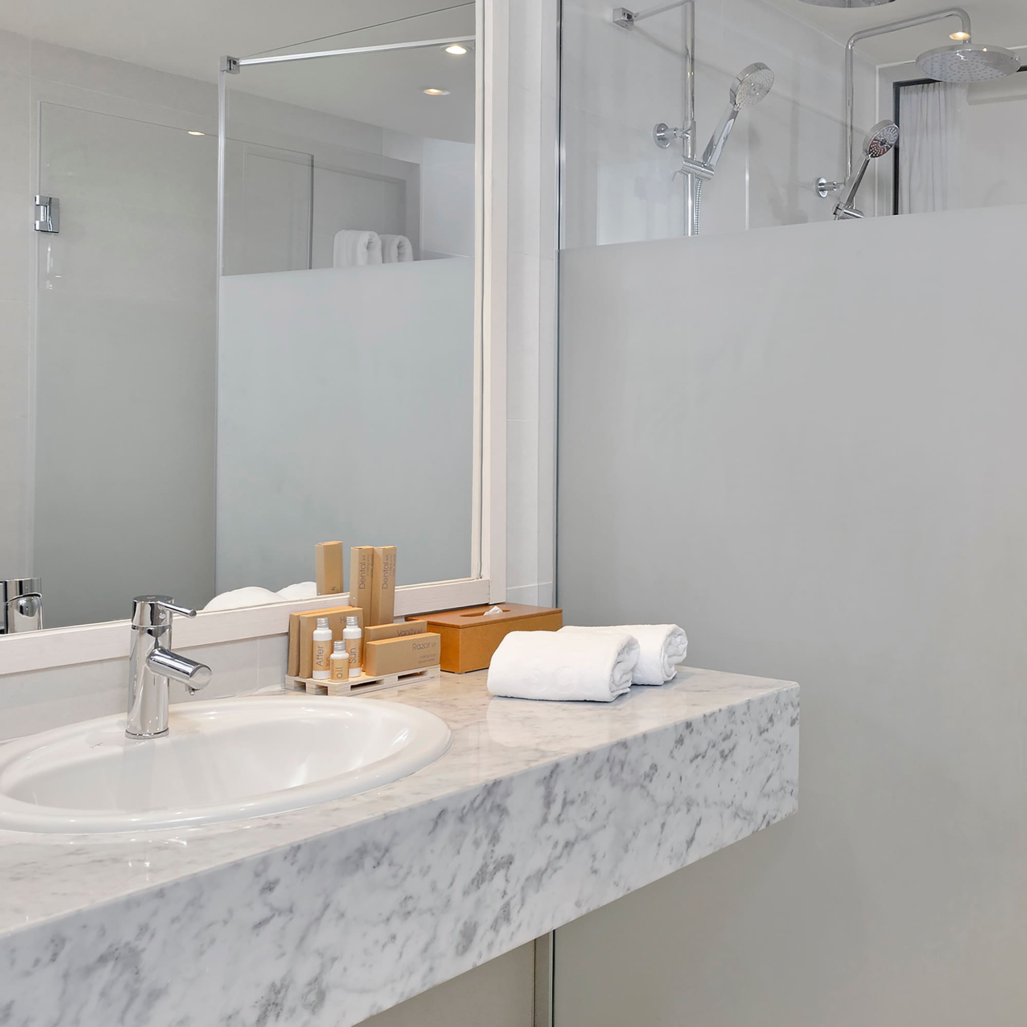 a bathroom with a marble countertop and a shower