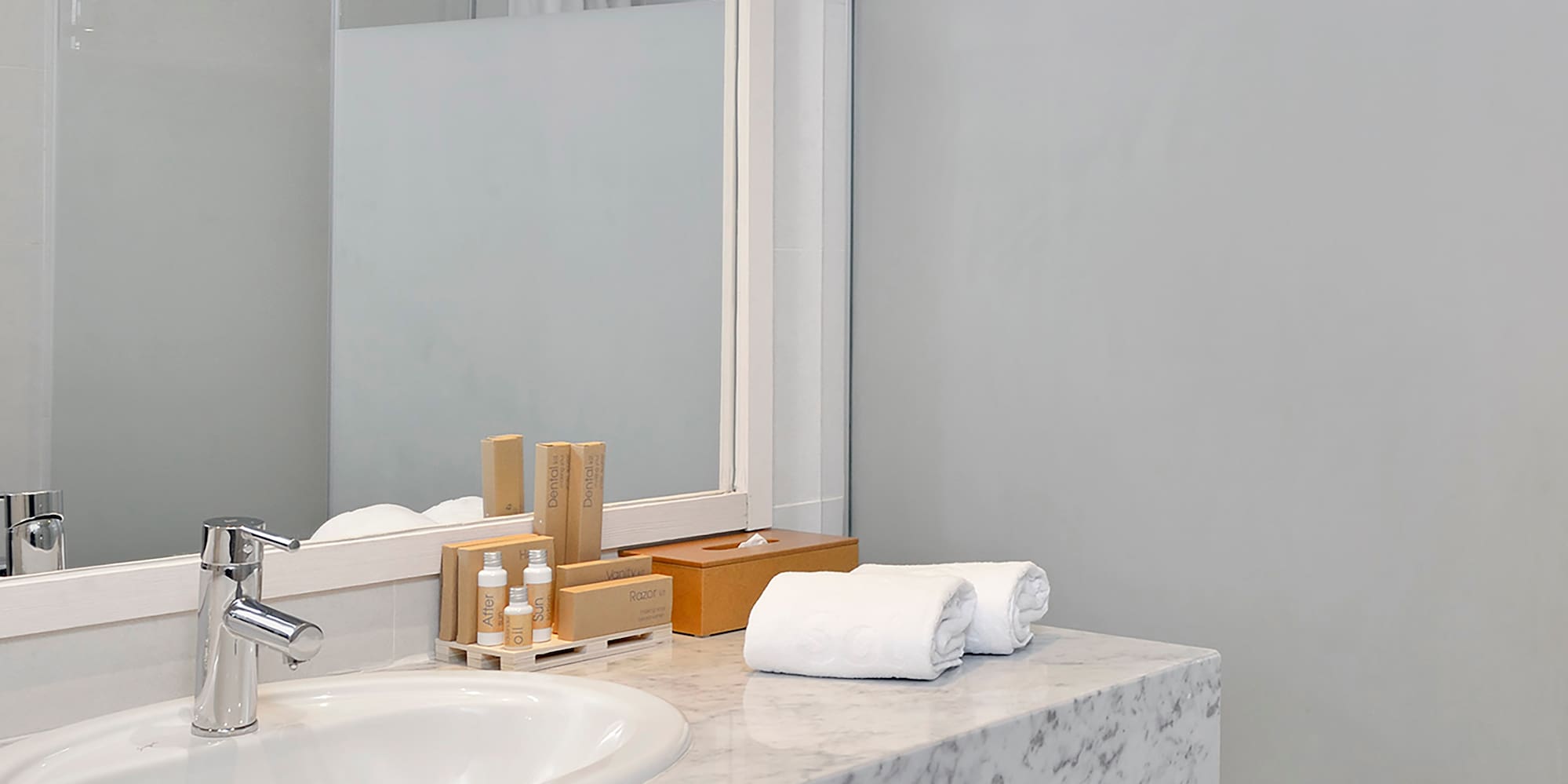 a bathroom with a marble countertop and a shower