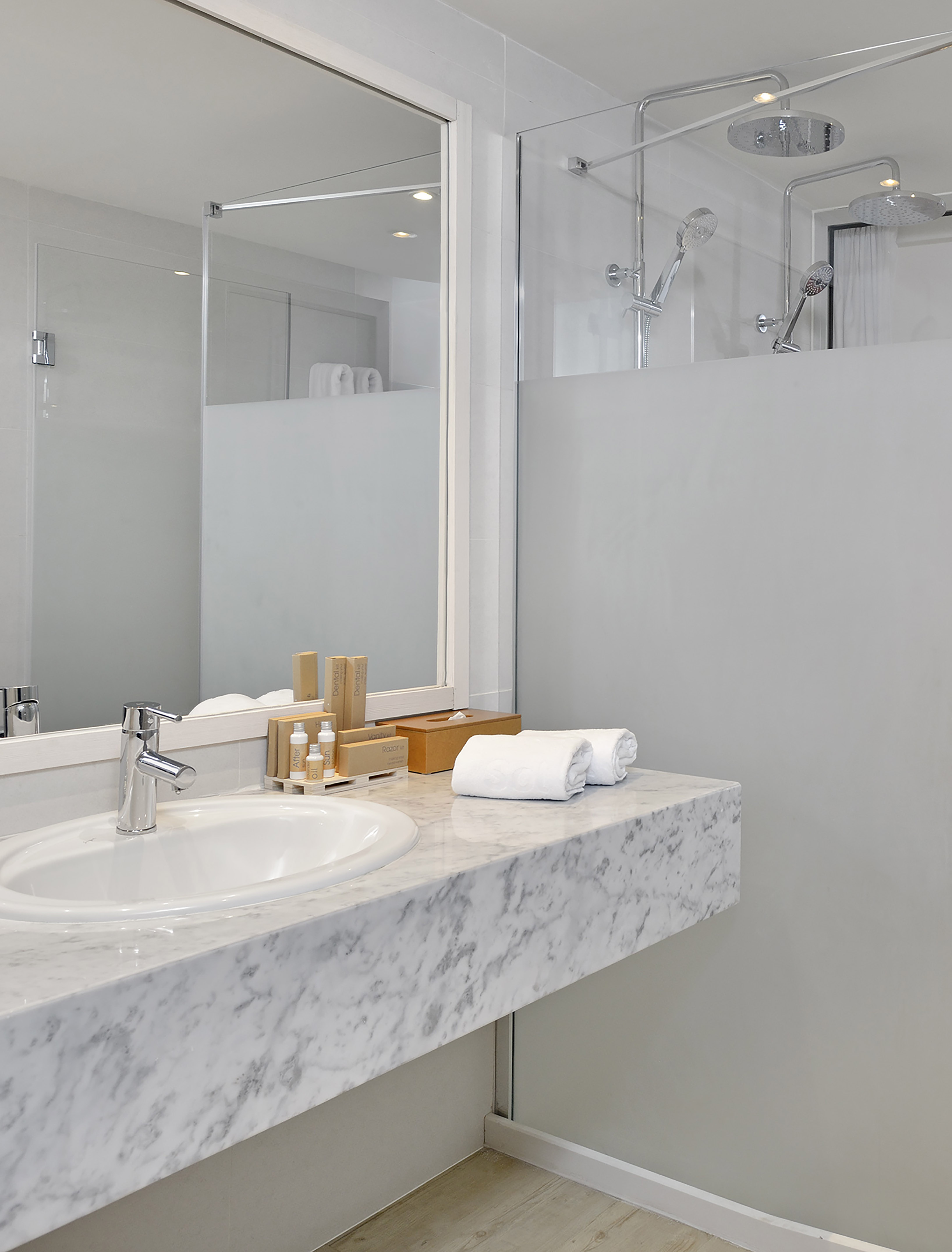 a bathroom with a marble countertop and a shower