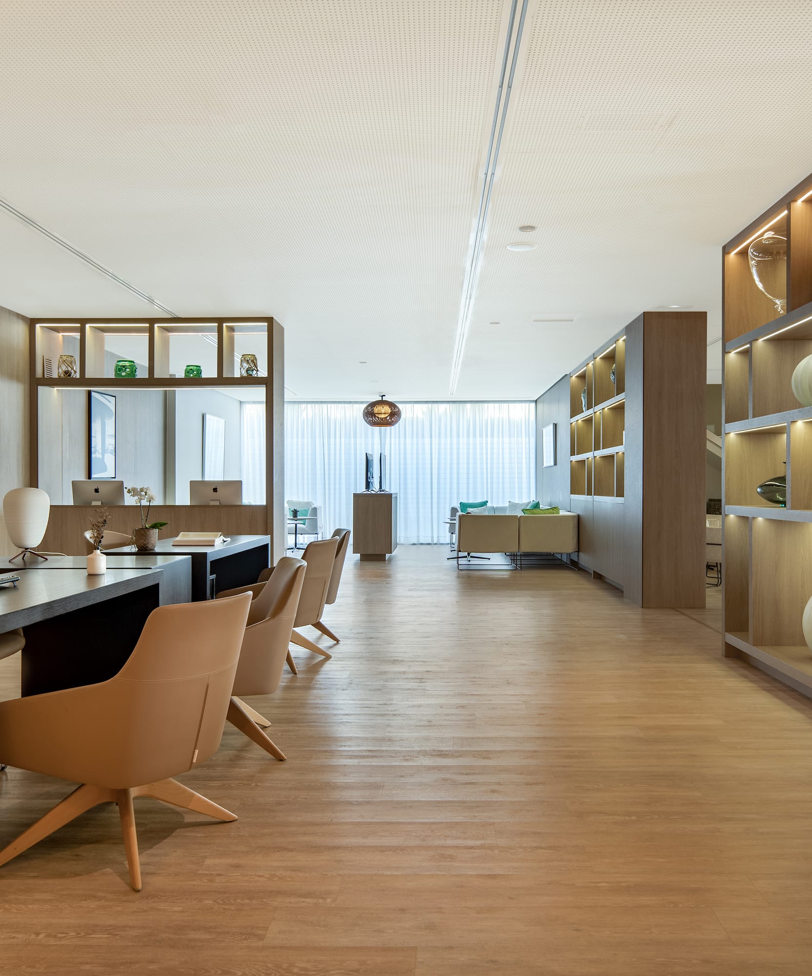 a room with a desk and chairs