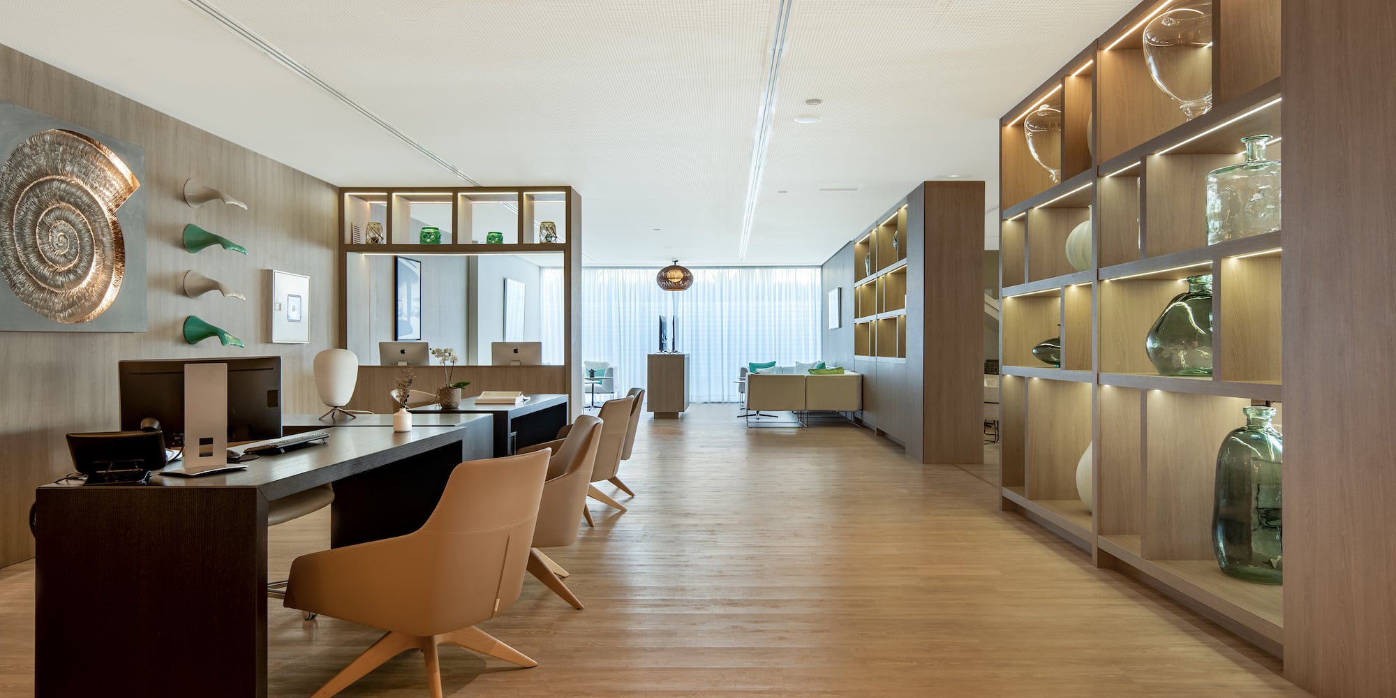 a room with a desk and chairs