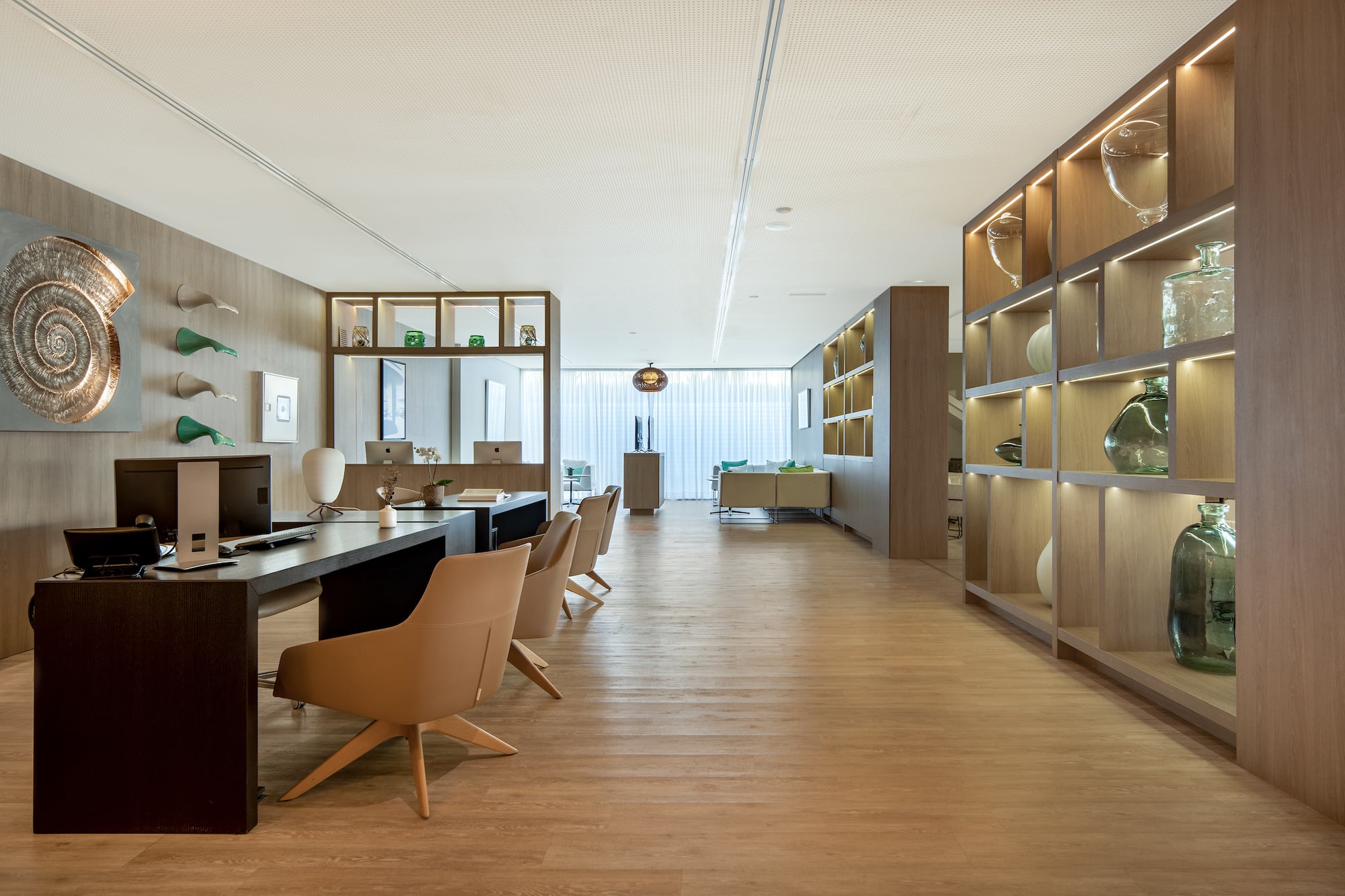 a room with a desk and chairs