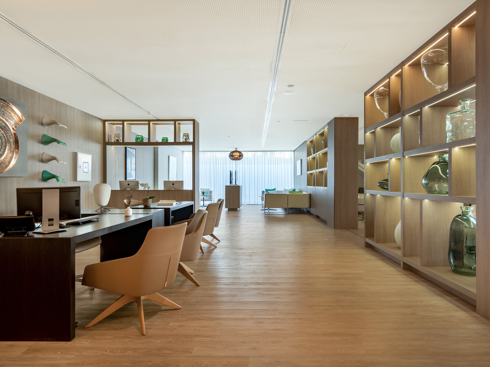 a room with a desk and chairs