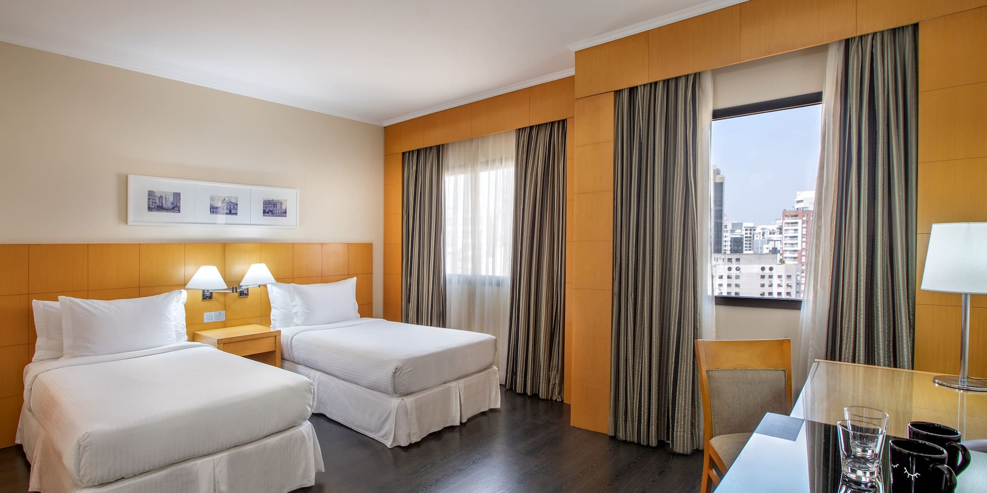 a room with two beds and a table