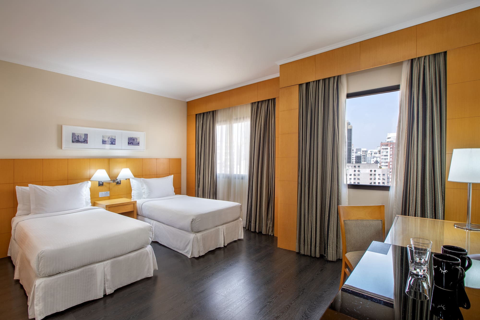 a room with two beds and a table