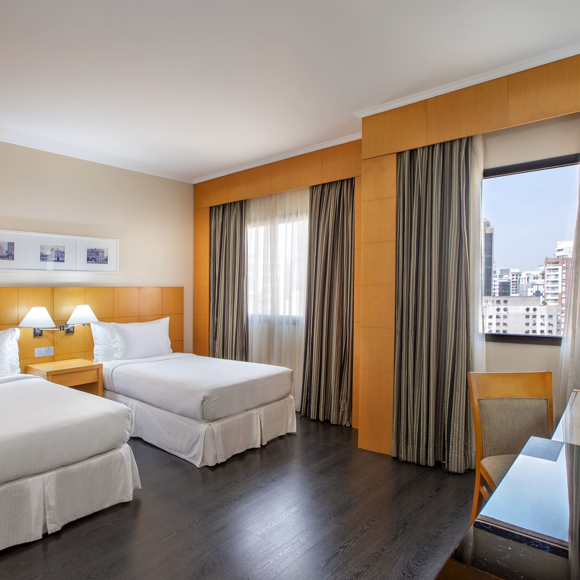 a room with two beds and a table