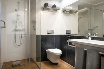 a bathroom with a shower and toilet