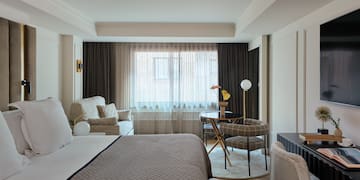 a bedroom with a bed and a table and chairs