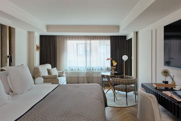 a bedroom with a bed and a table and chairs