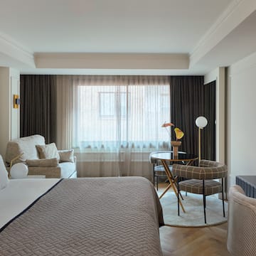 a bedroom with a bed and a table and chairs