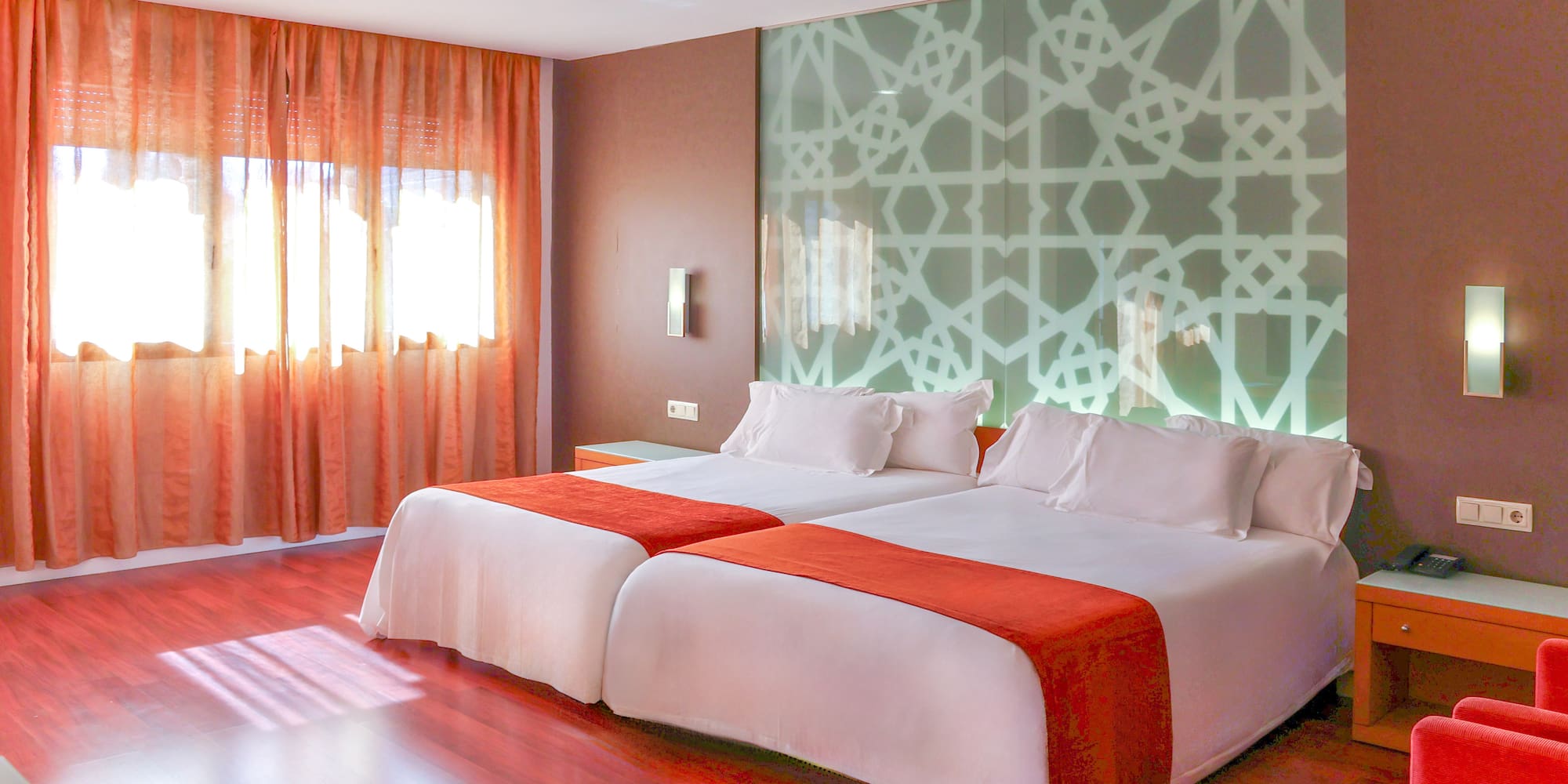 a room with two beds and a window