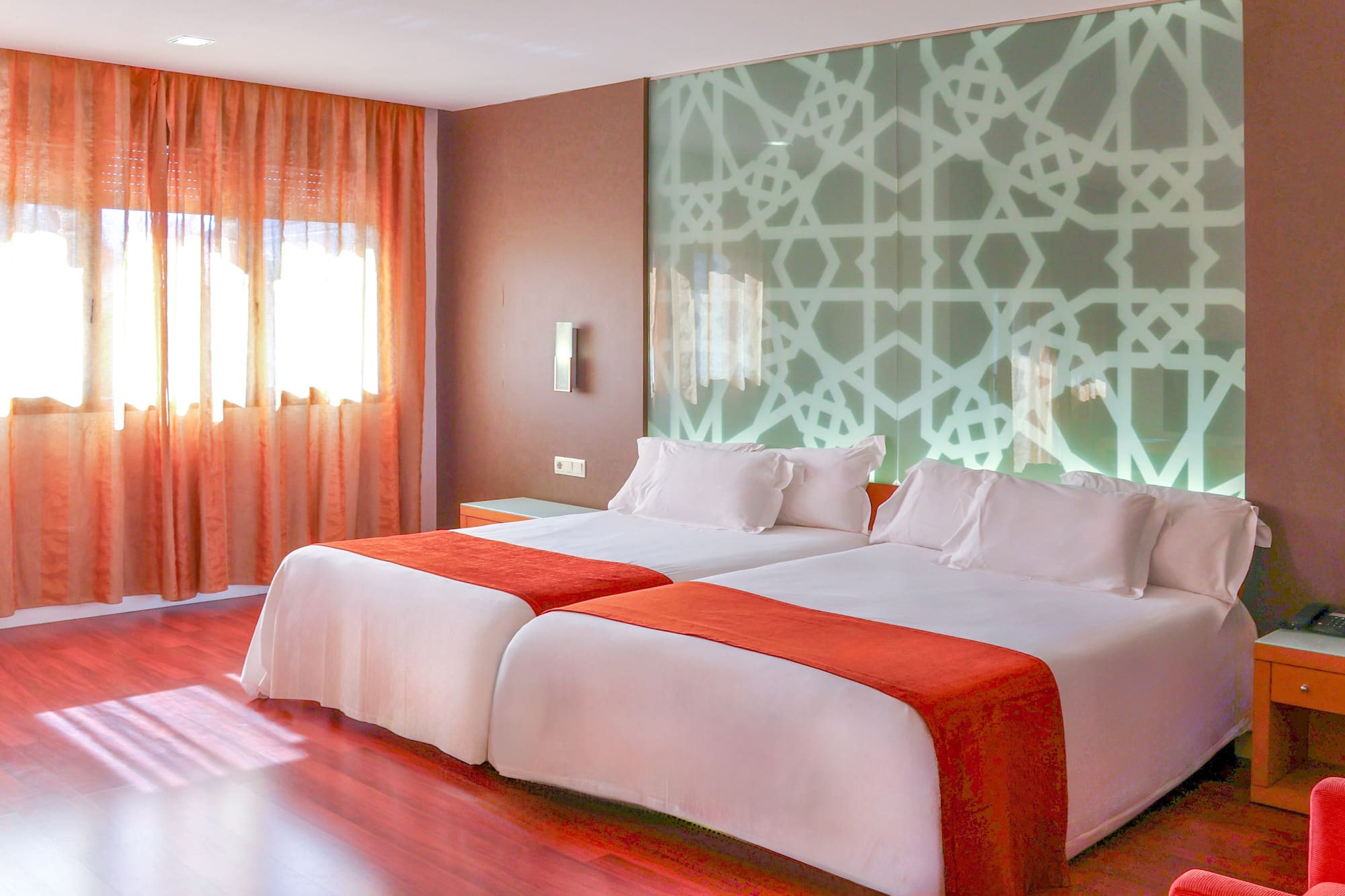 a room with two beds and a window