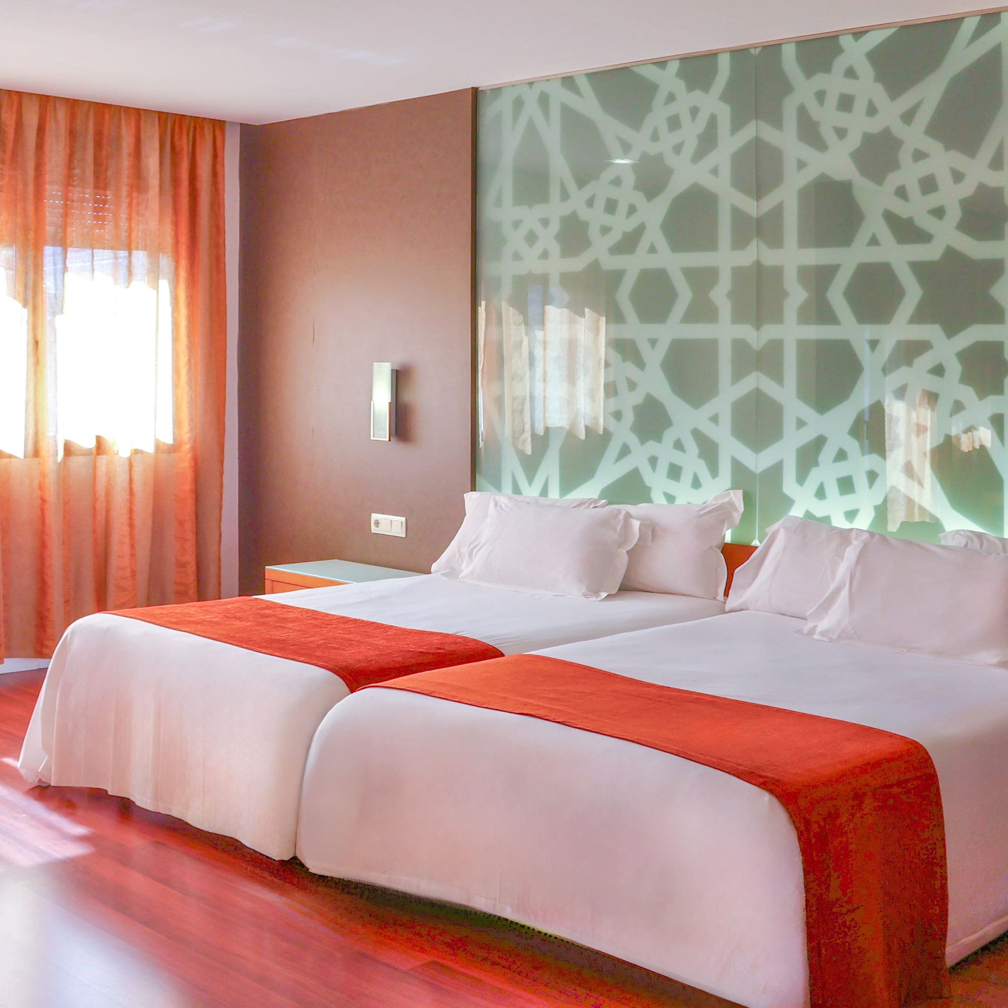 a room with two beds and a window