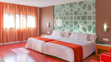 a room with two beds and a window