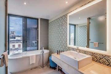 a bathroom with a tub and sink