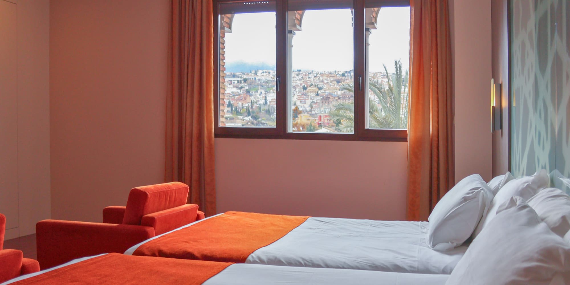 a room with two beds and a window