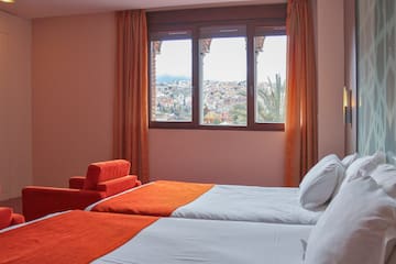 a room with two beds and a window