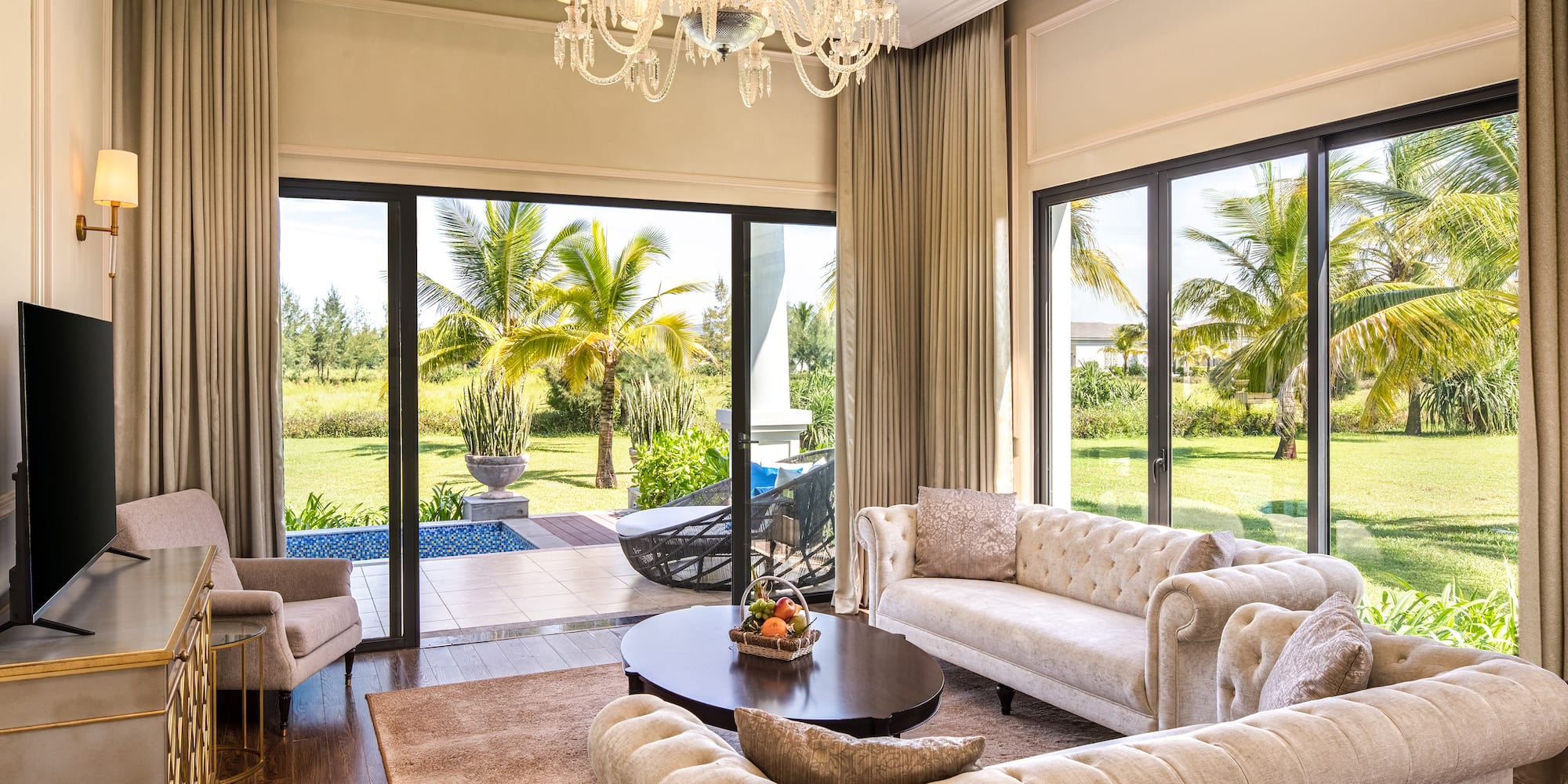 a living room with a chandelier and couches