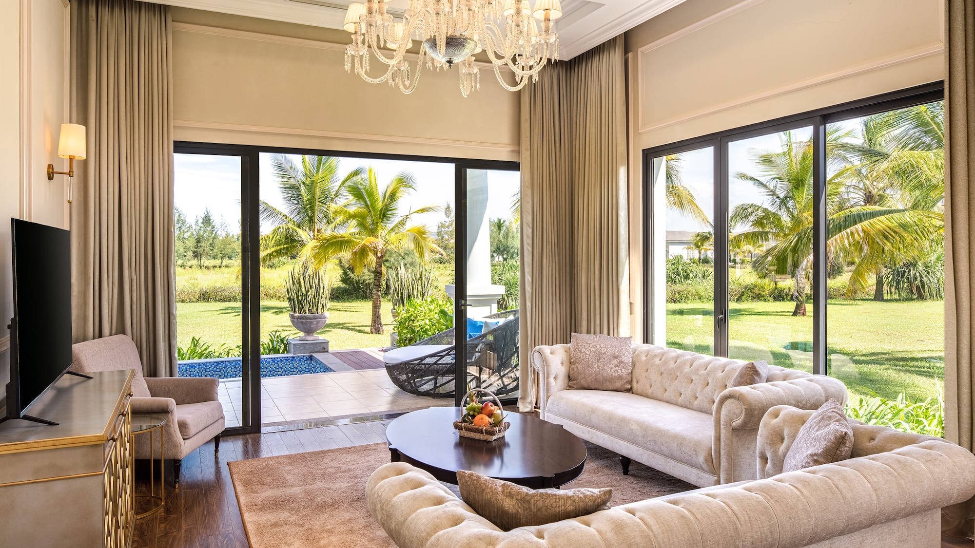 a living room with a chandelier and couches