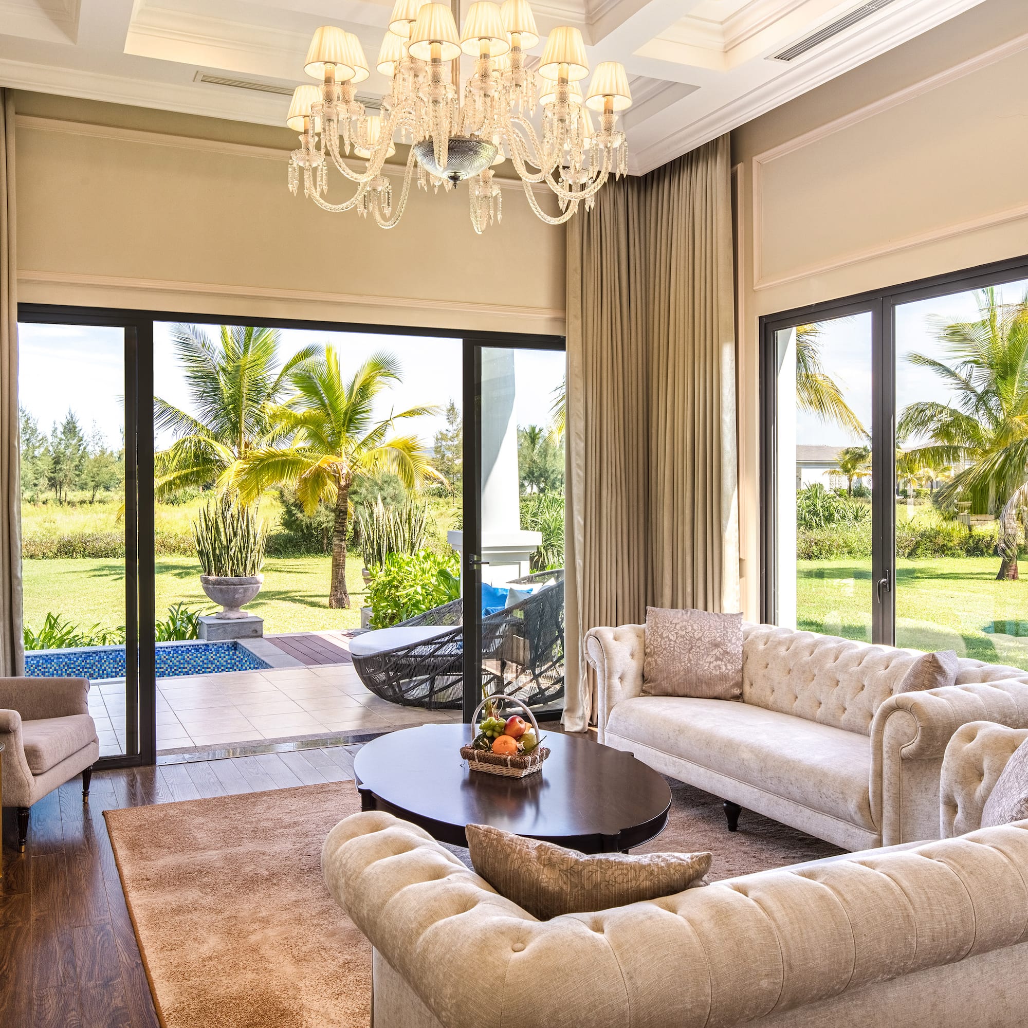 a living room with a chandelier and couches