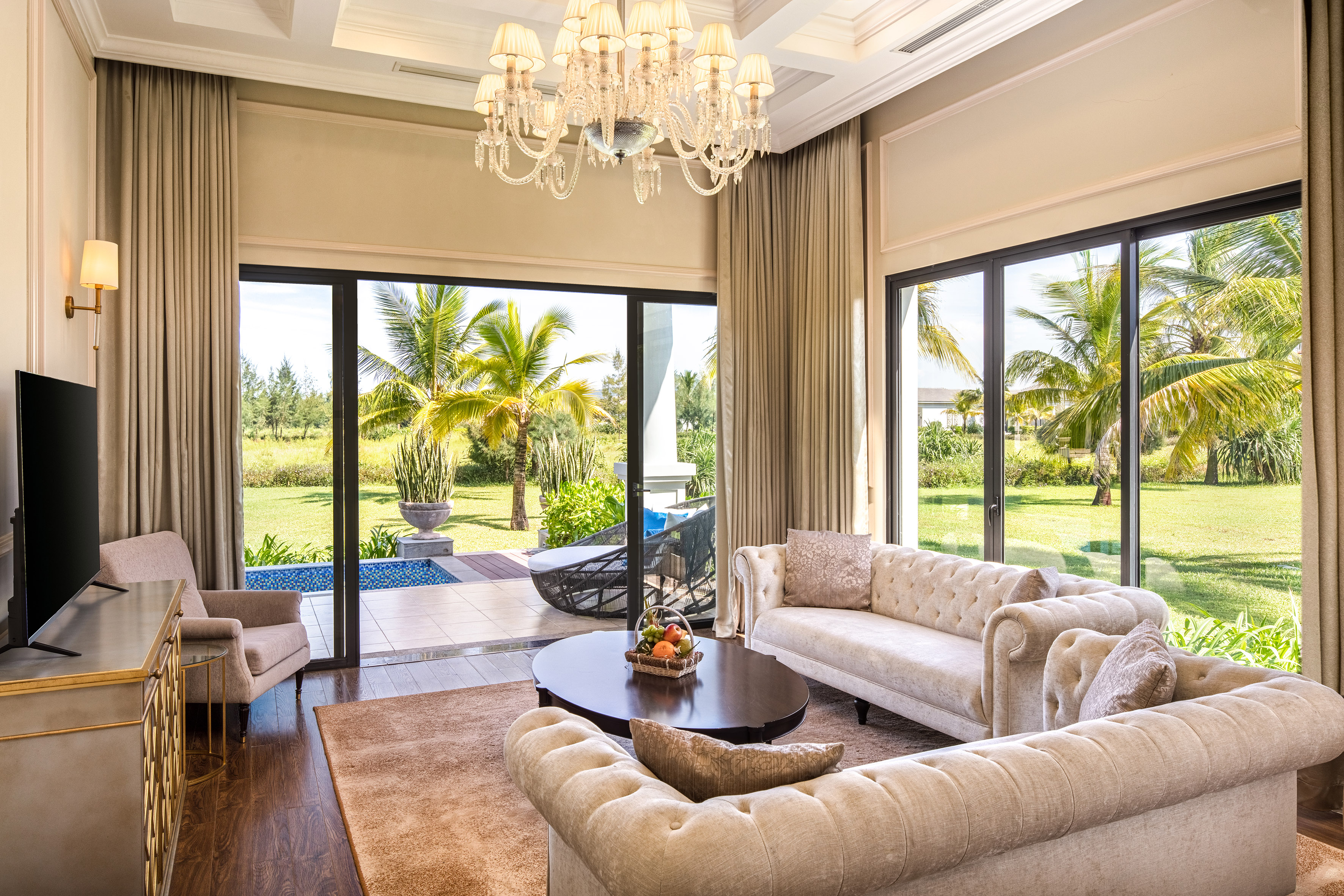 a living room with a chandelier and couches
