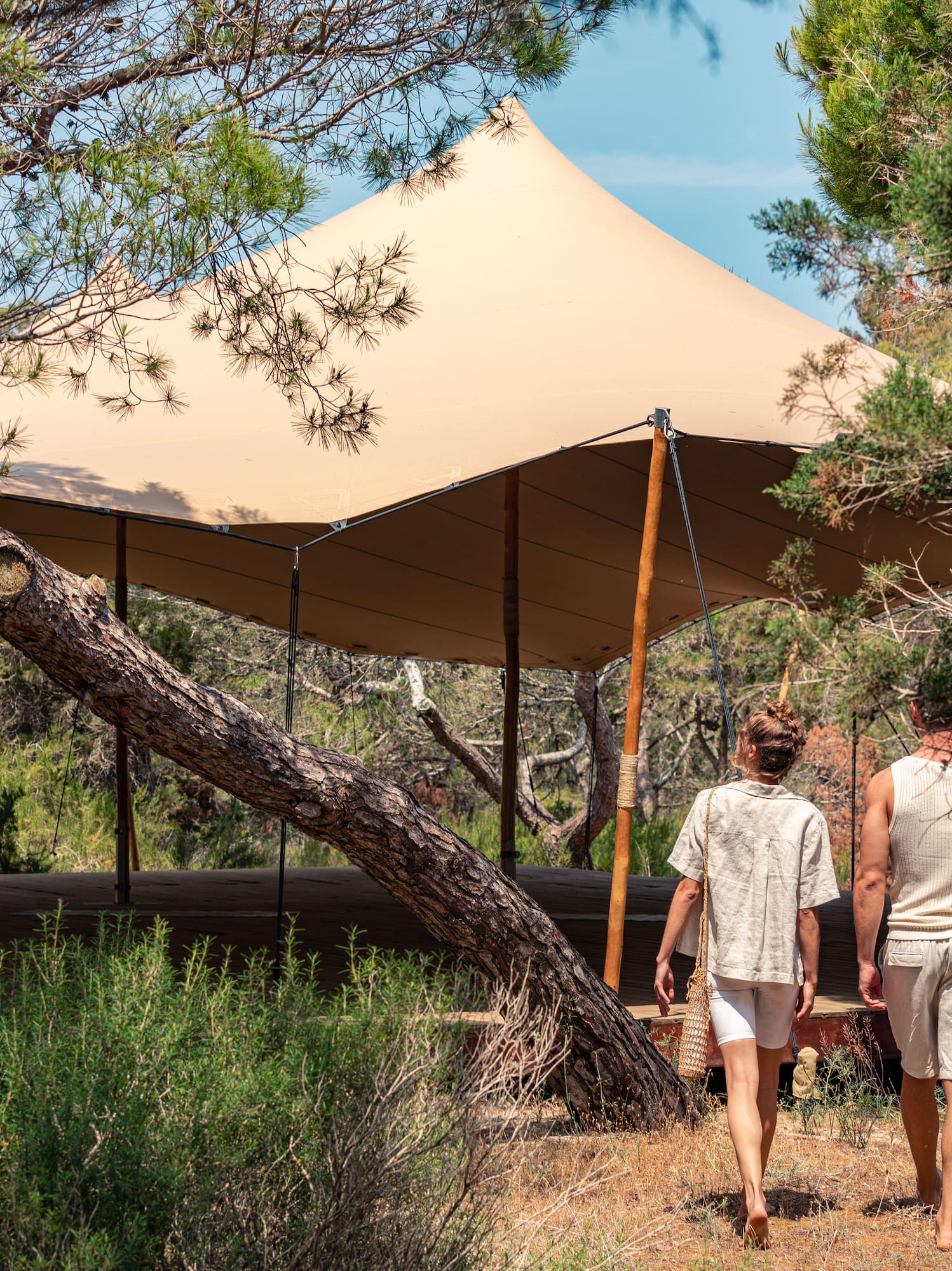 two people walking under a tent