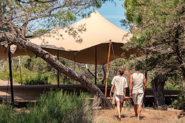 two people walking under a tent