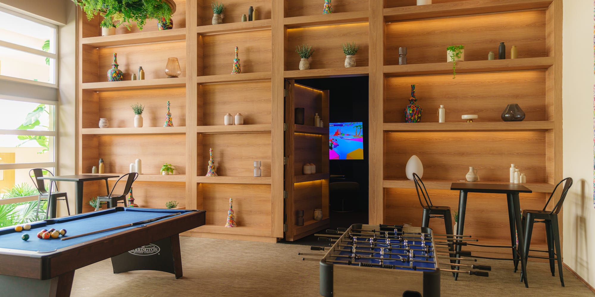 a room with a pool table and a table and chairs