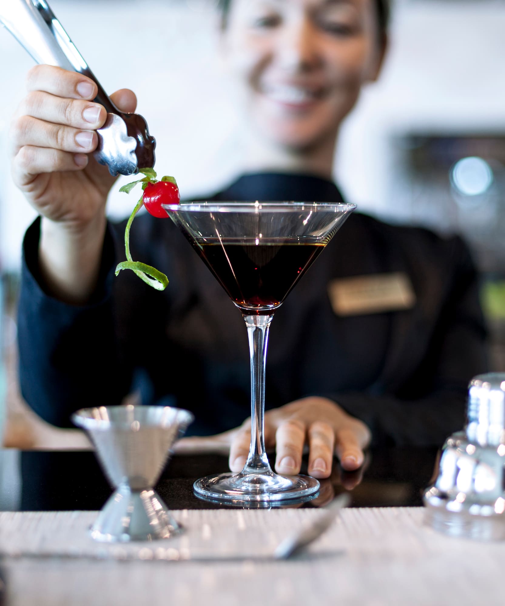 a person pouring a drink into a glass