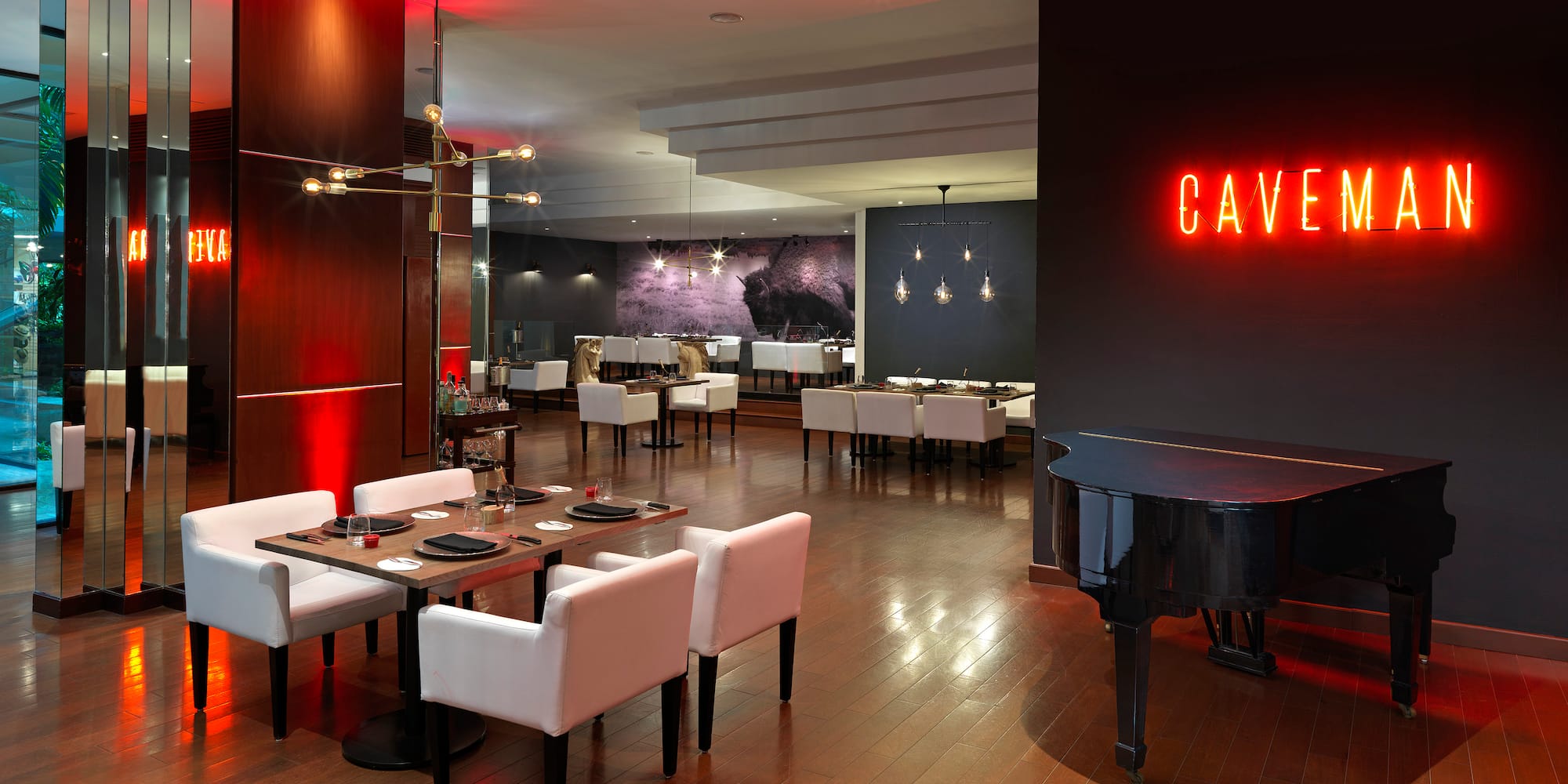 a room with a piano and tables