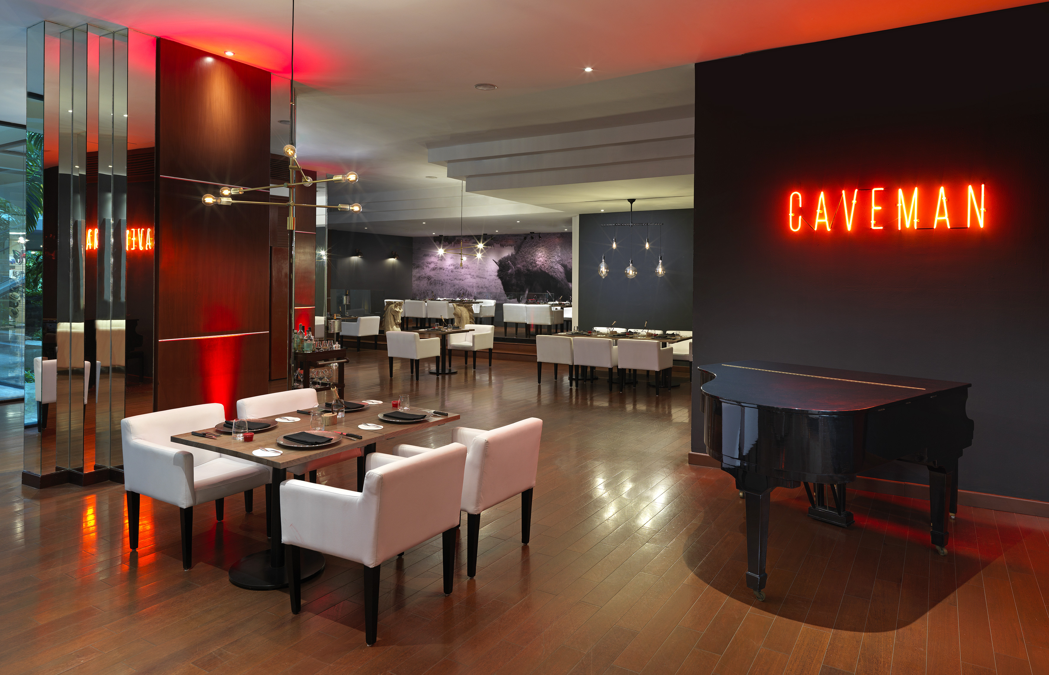 a room with a piano and tables