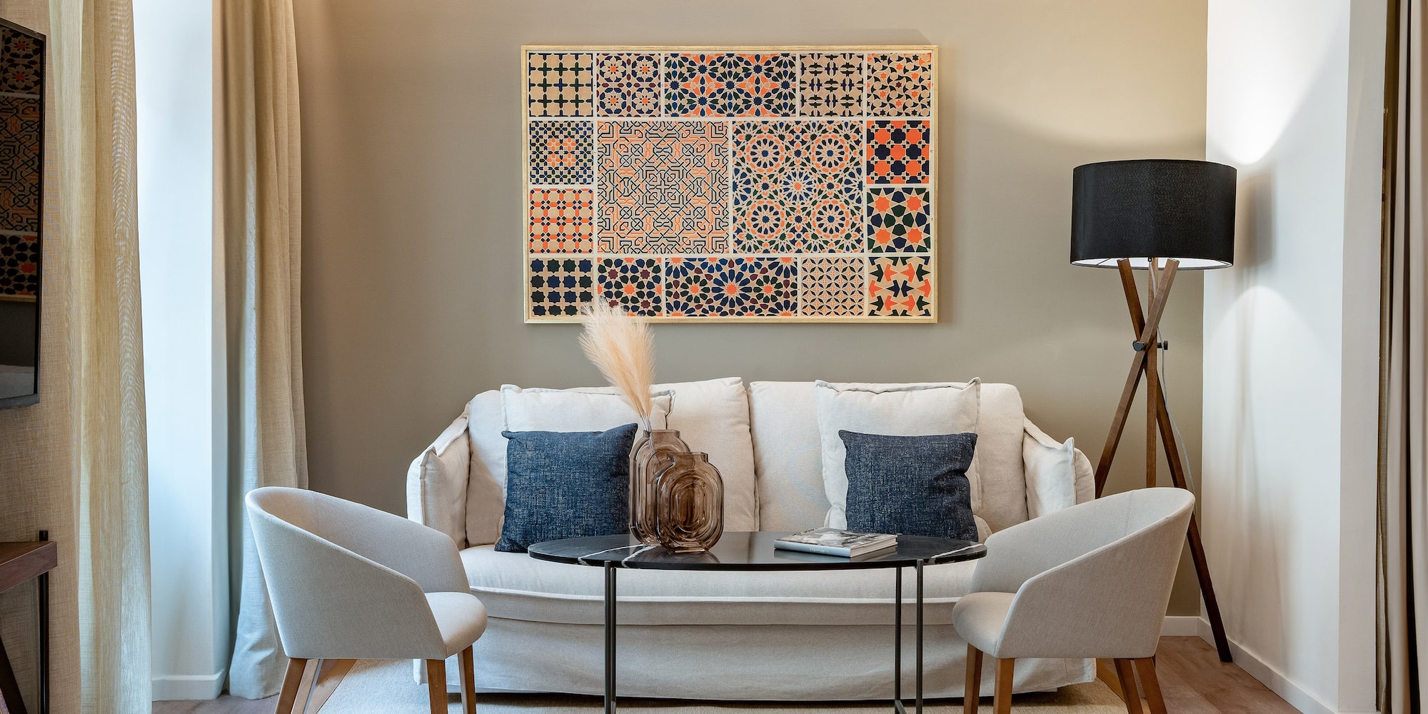 a room with a couch and two chairs