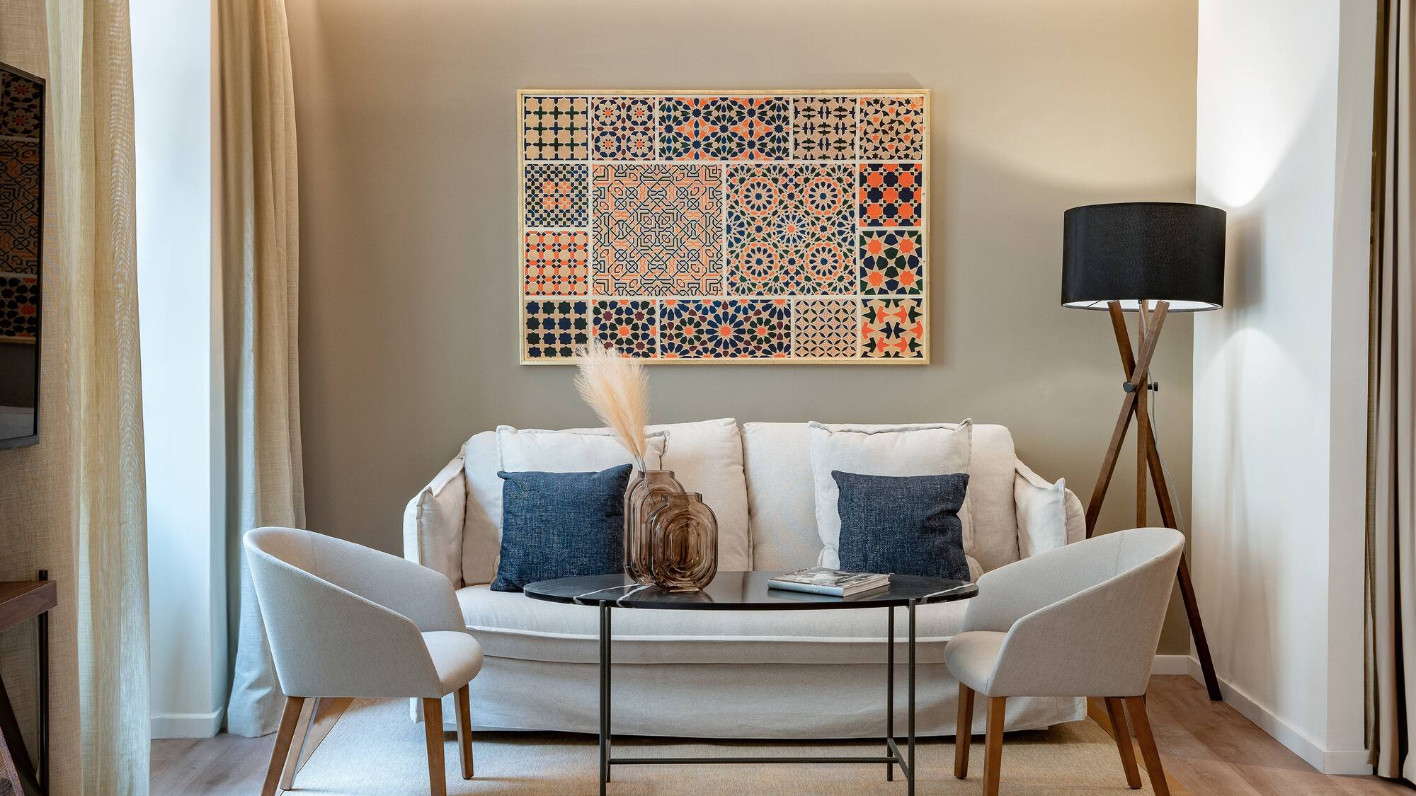 a room with a couch and two chairs