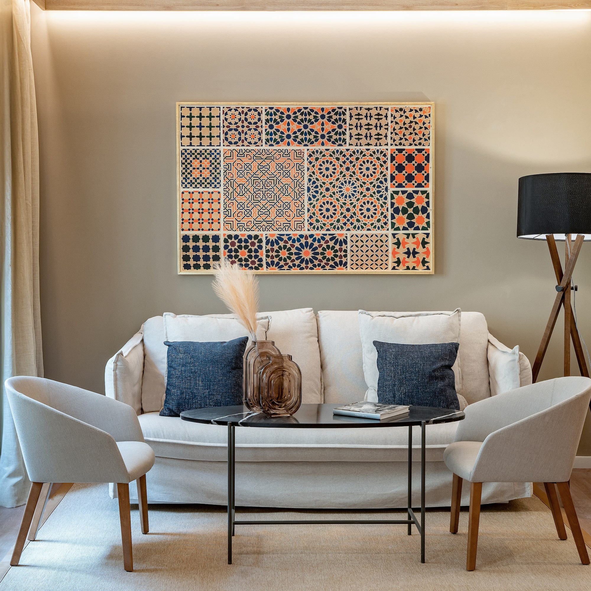 a room with a couch and two chairs