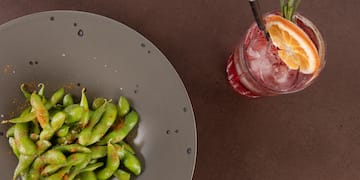 a plate of food next to a drink