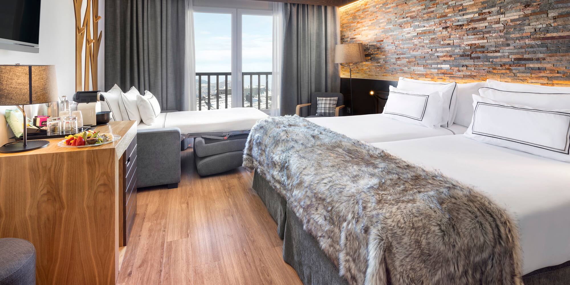 a room with two beds and a bed and a table