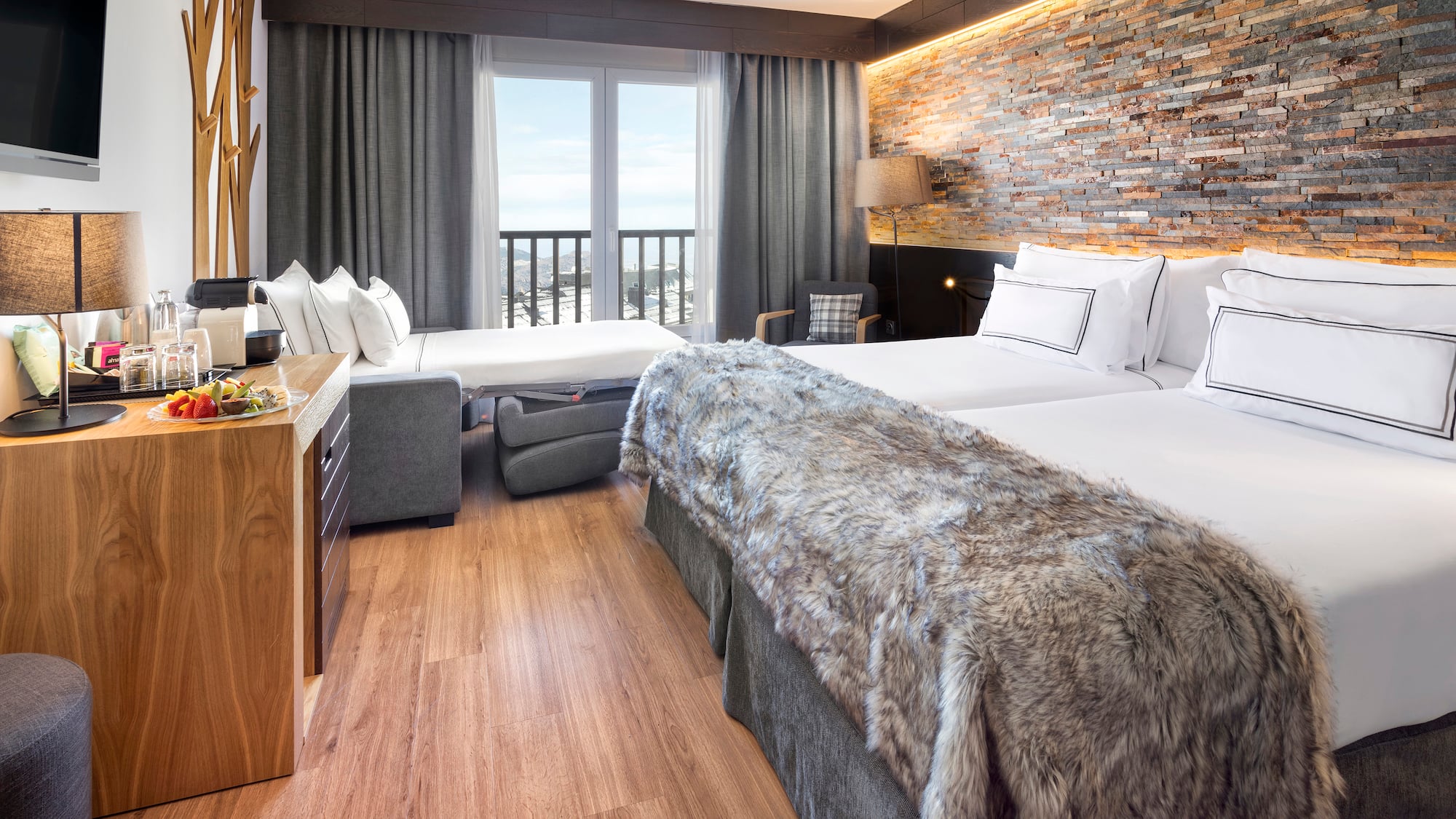 a room with two beds and a bed and a table