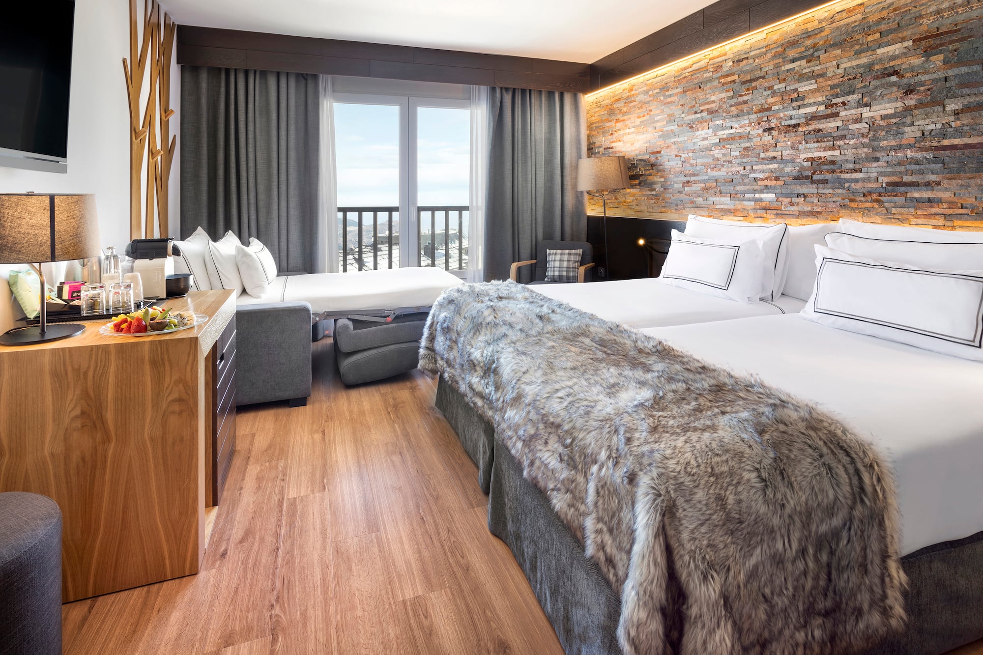 a room with two beds and a bed and a table