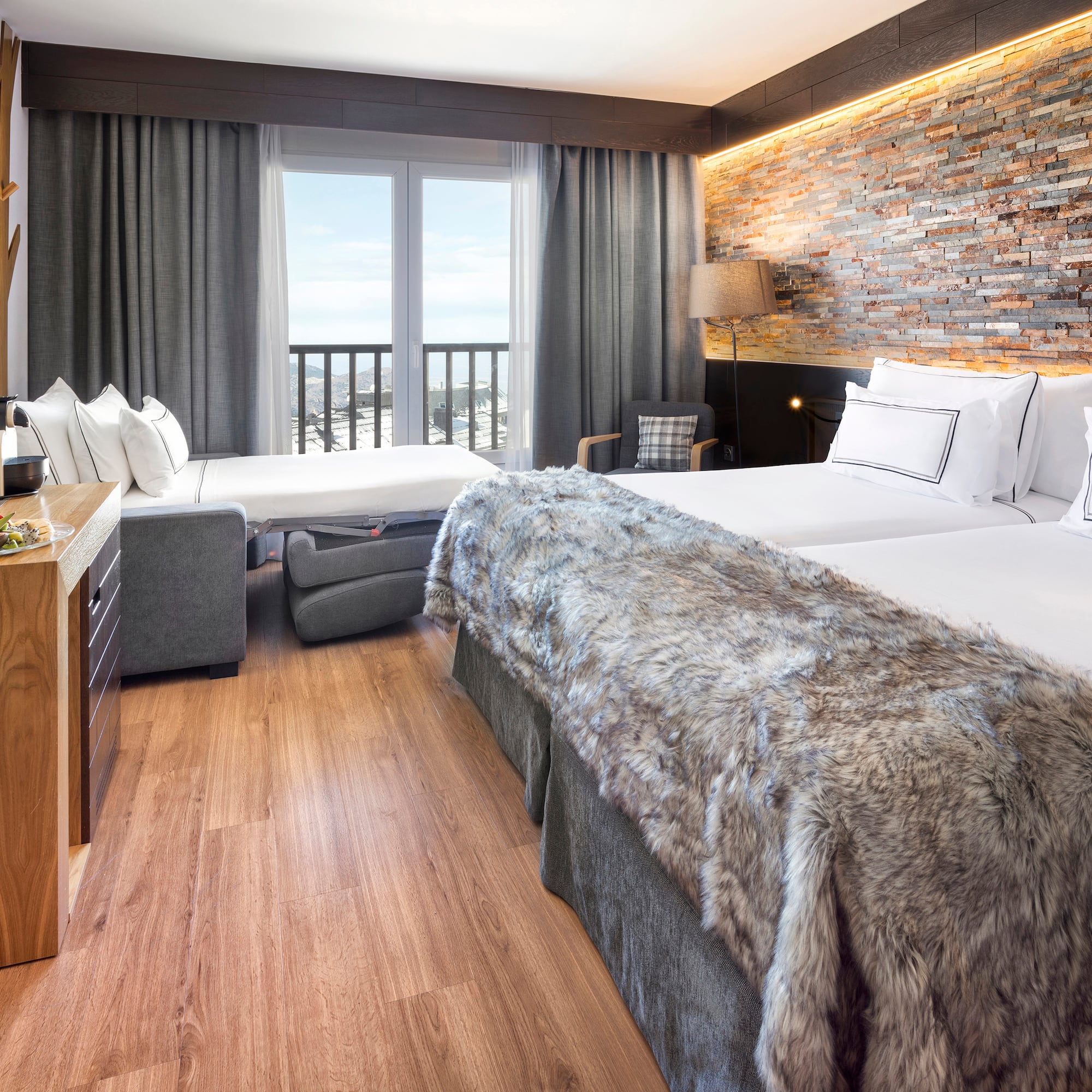 a room with two beds and a bed and a table