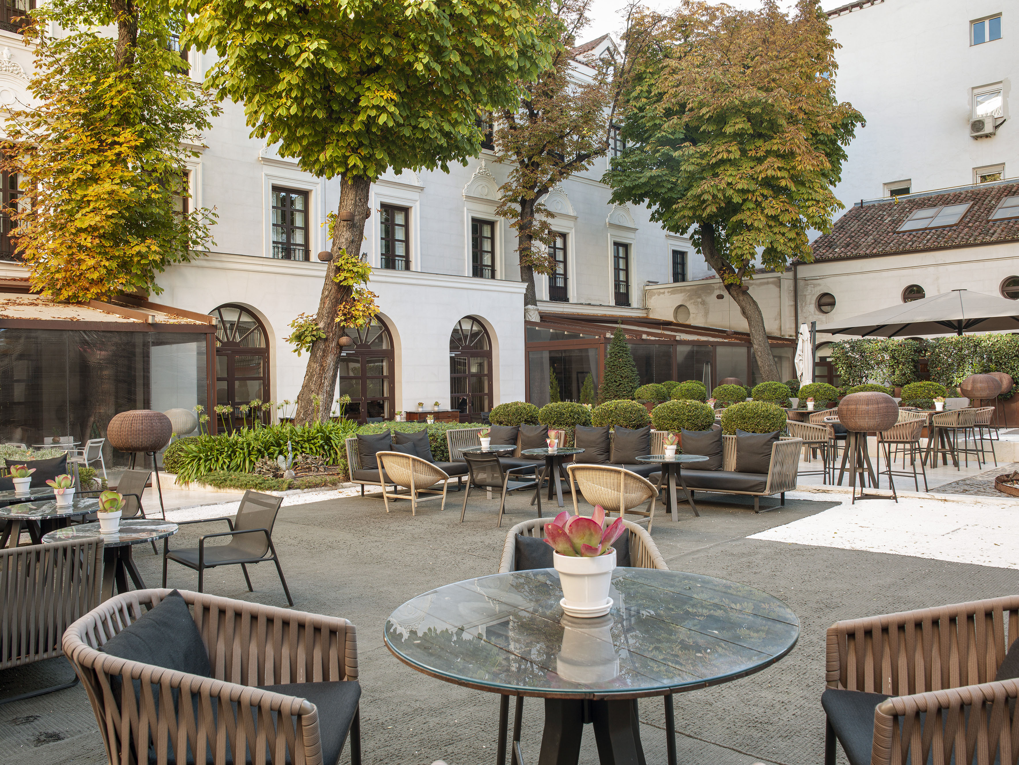 a patio area with chairs and tables