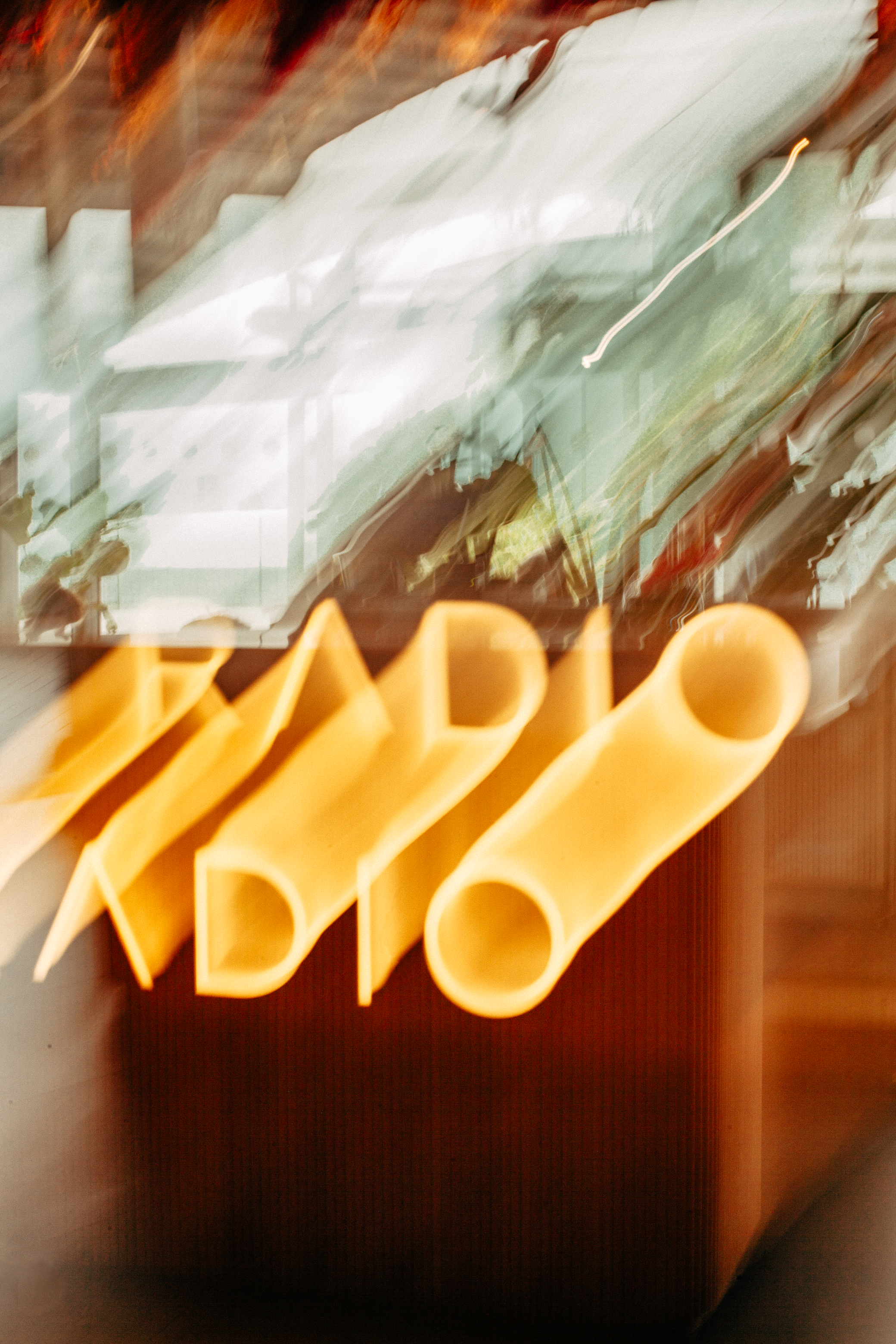 Motion-blurred yellow tubular letters PADI against an abstract background.
