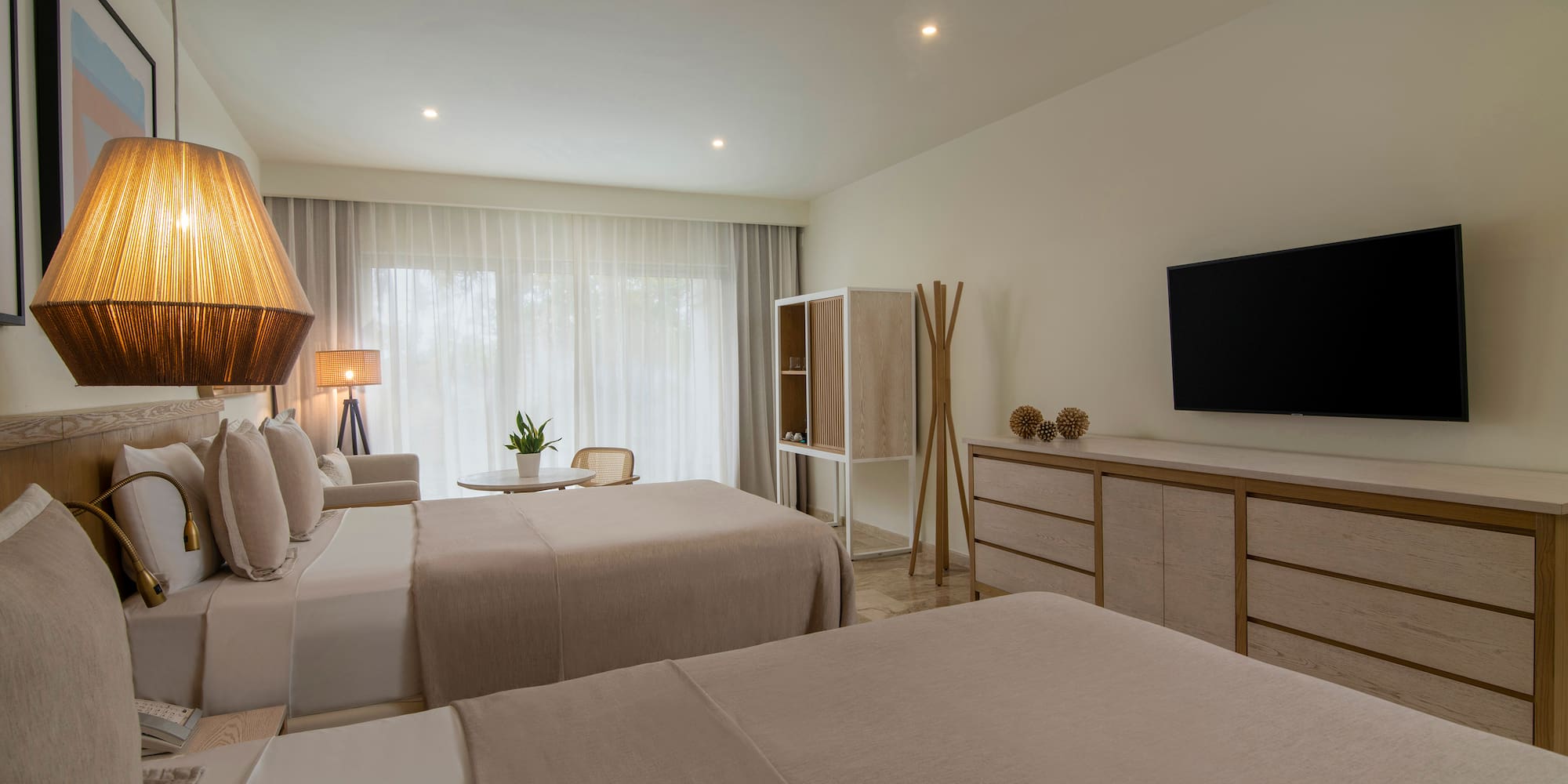 a room with two beds and a tv