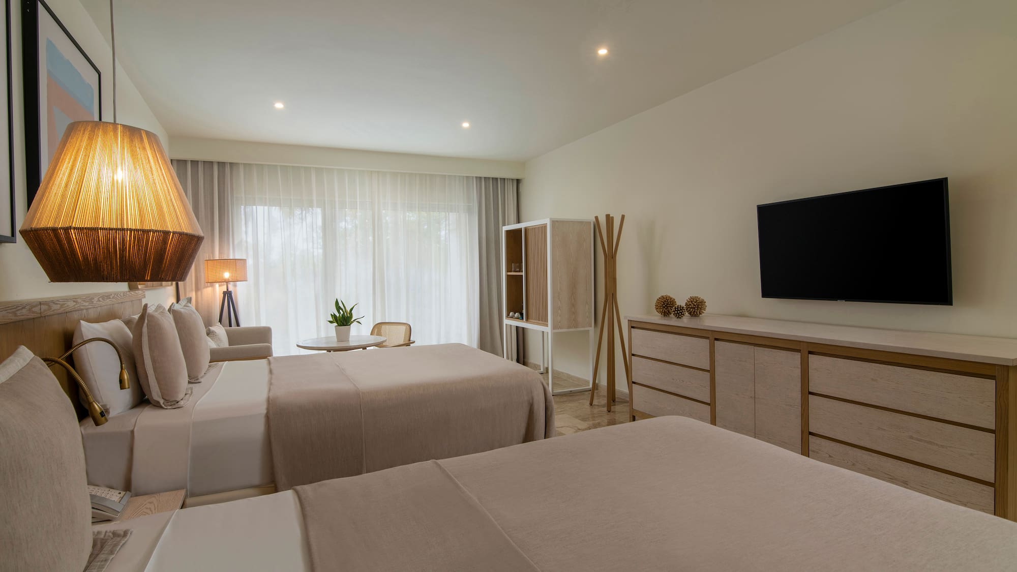 a room with two beds and a tv